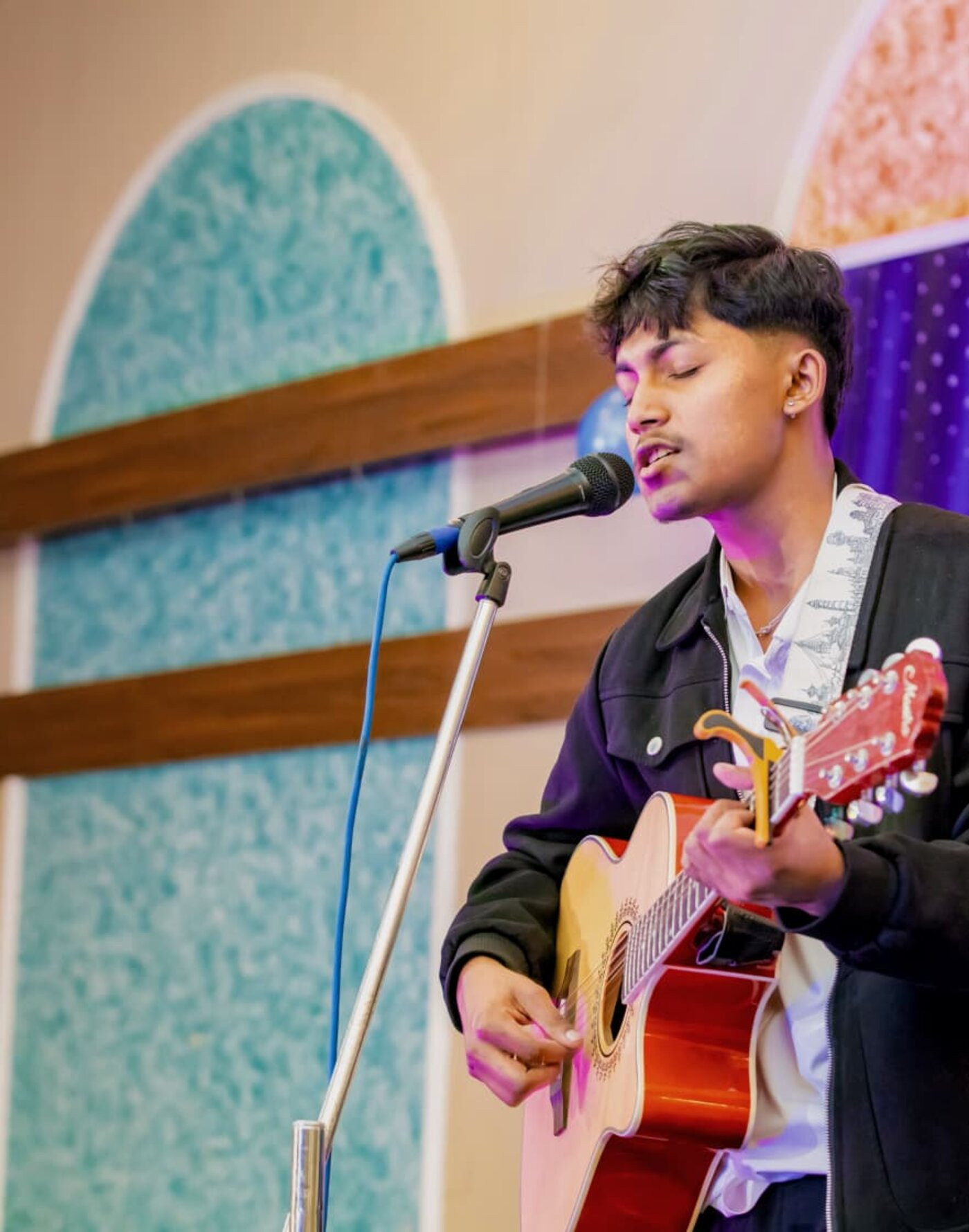 Sudip performing with guitar