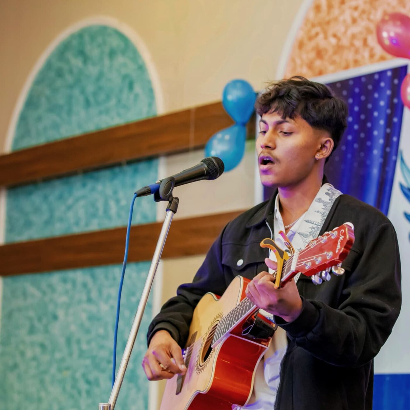 Sudip singing and playing guitar